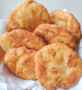 A pile of 2-ingredient vetkoek in a basket.