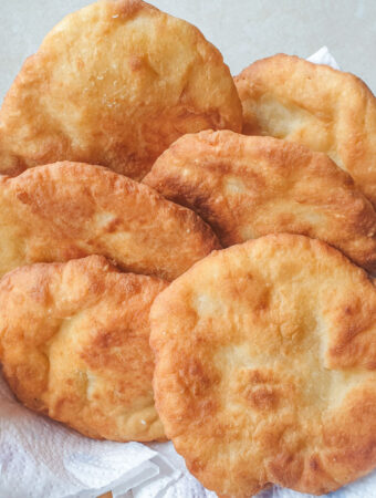 A pile of 2-ingredient vetkoek in a basket.