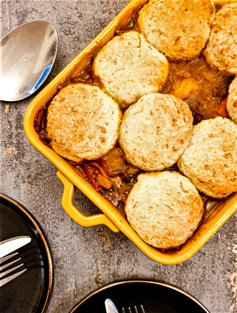 Overhead shot of beef cobbler, covered with cheese scones.