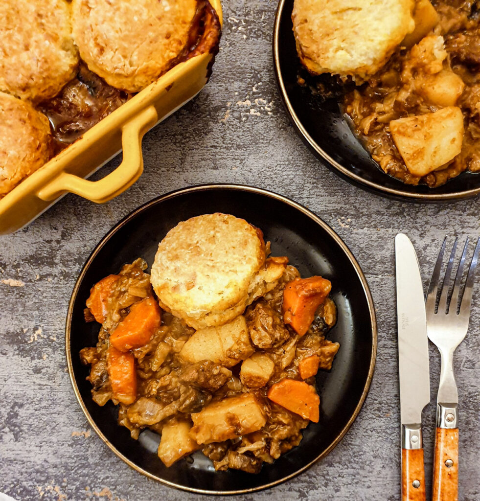 A plate of beef cobbler, with a helping of scone topping.