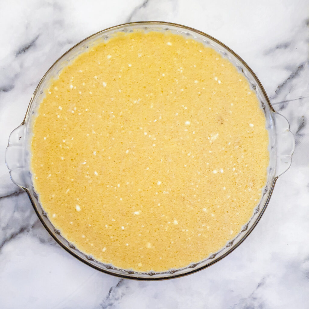 Batter for an impossible Christmas pie in a baking dish.