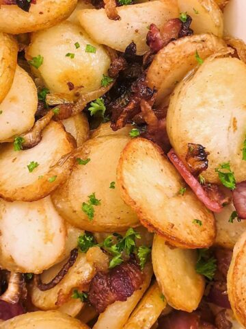 Close up of German fried potatoes with bacon and onion