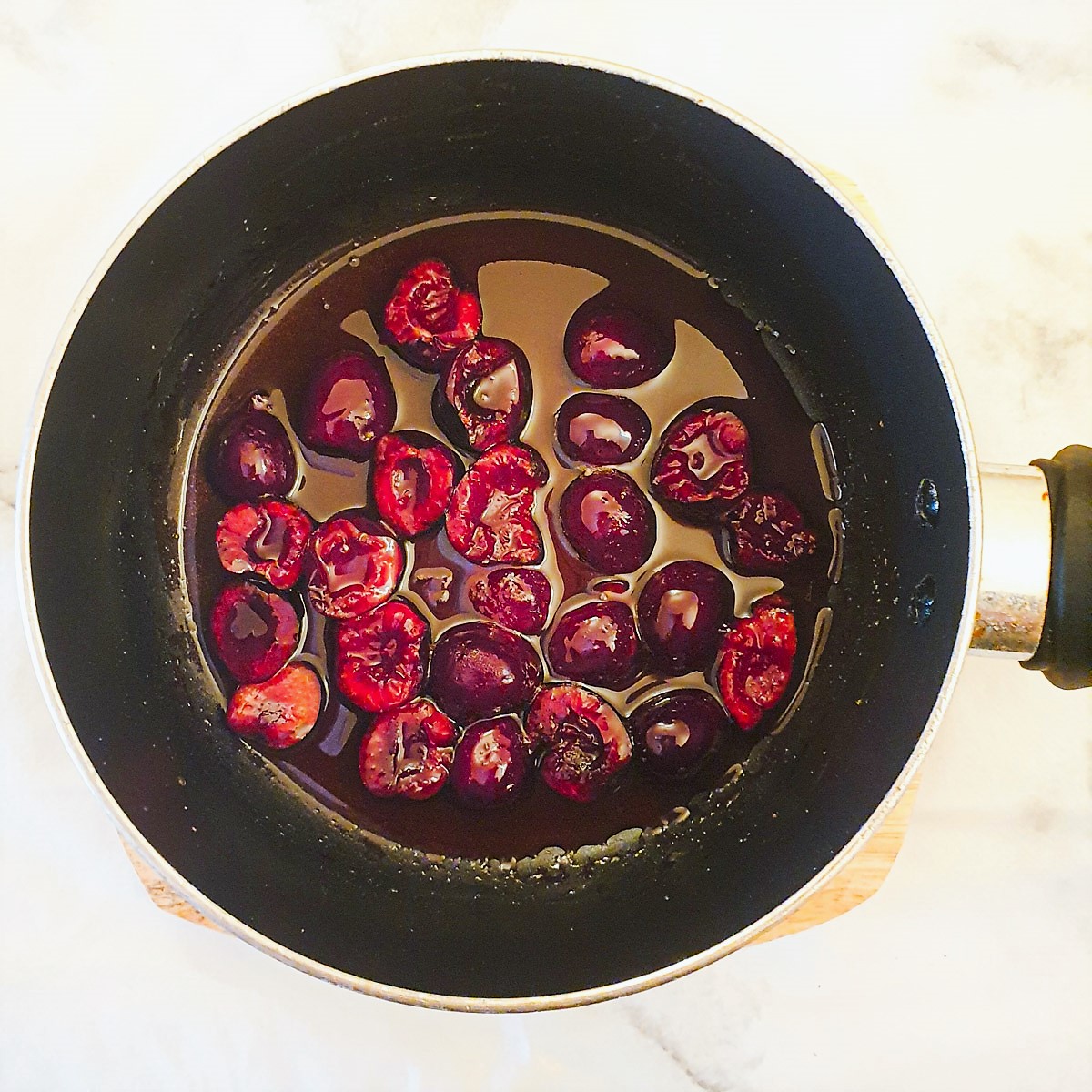 Cherry sauce being boiled in a saucepan.