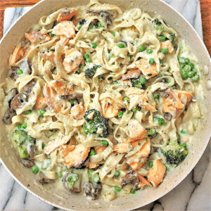 Salmon and broccoli pasta in a frying pan.