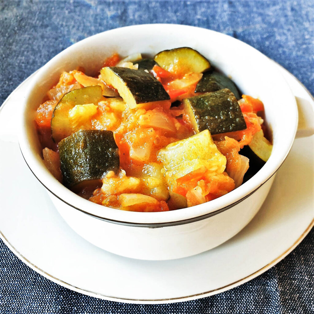 A dish of baby marrows cooked in tomatoes and onions.