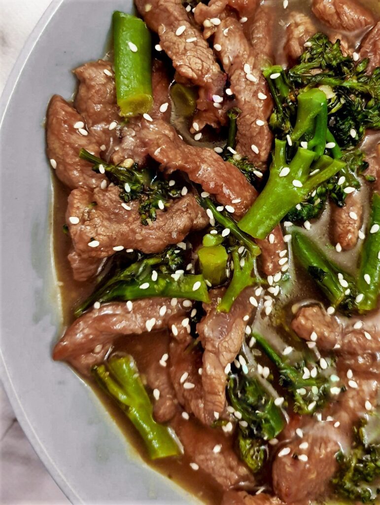 Overhead shot of beef and broccoli stir fry showing the stirps of beef and broccoli in the thick tasty sauce.