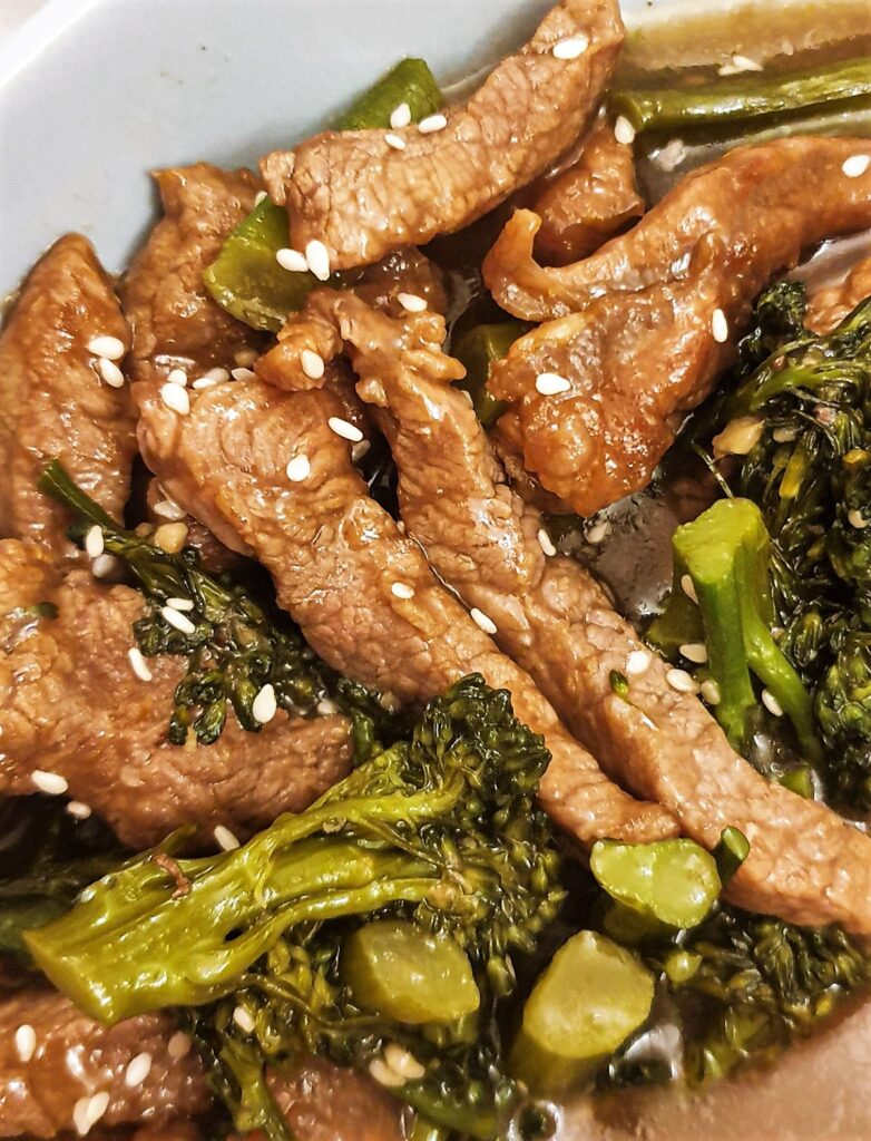 Close up of the strips of beef and broccoli sprinkled with sesame seeds.