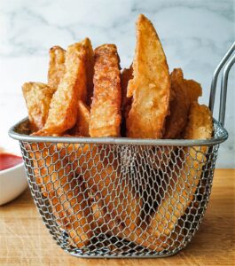 A wire basket of crispy fries.