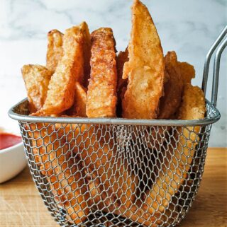 A wire basket of crispy fries.