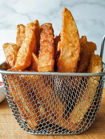 A wire basket of crispy fries.