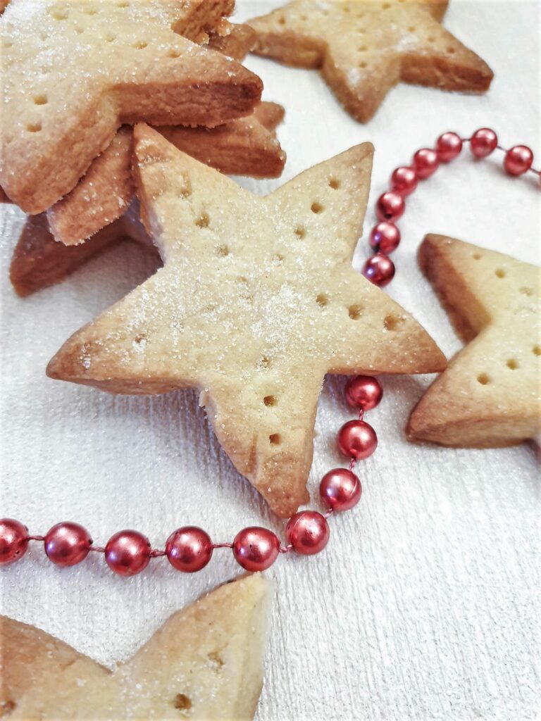 Close up of a shortbread star dusted with caster sugar.