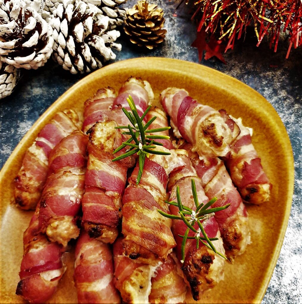 A plate of festive pigs in blankets.