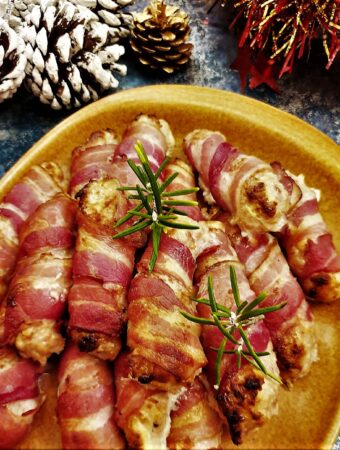 A plate of festive pigs in blankets.