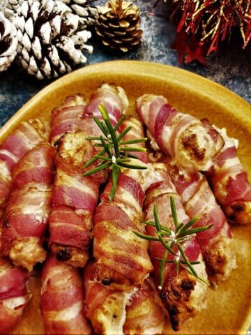 A plate of festive pigs in blankets.