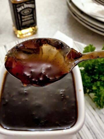 A spoonful of Jack Daniels dipping sauce showing the consistency.