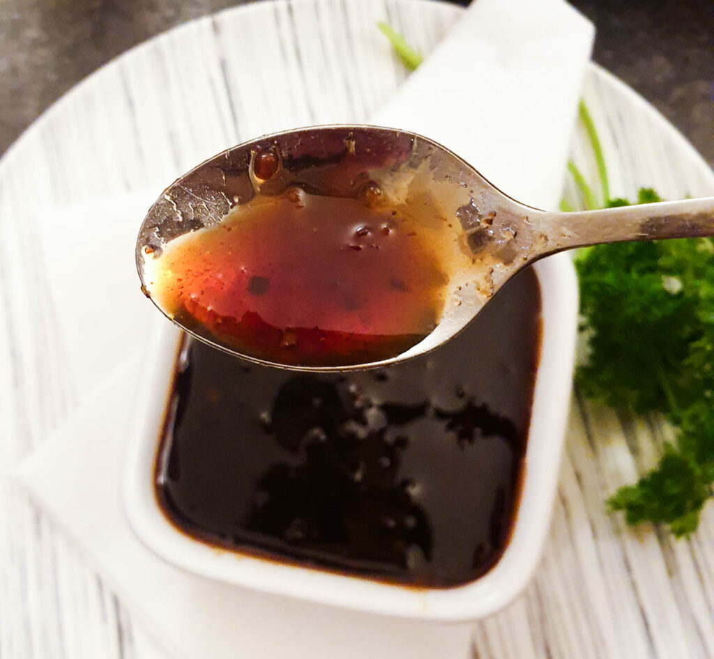 A spoonful of sauce, showing the syrupy consistency.