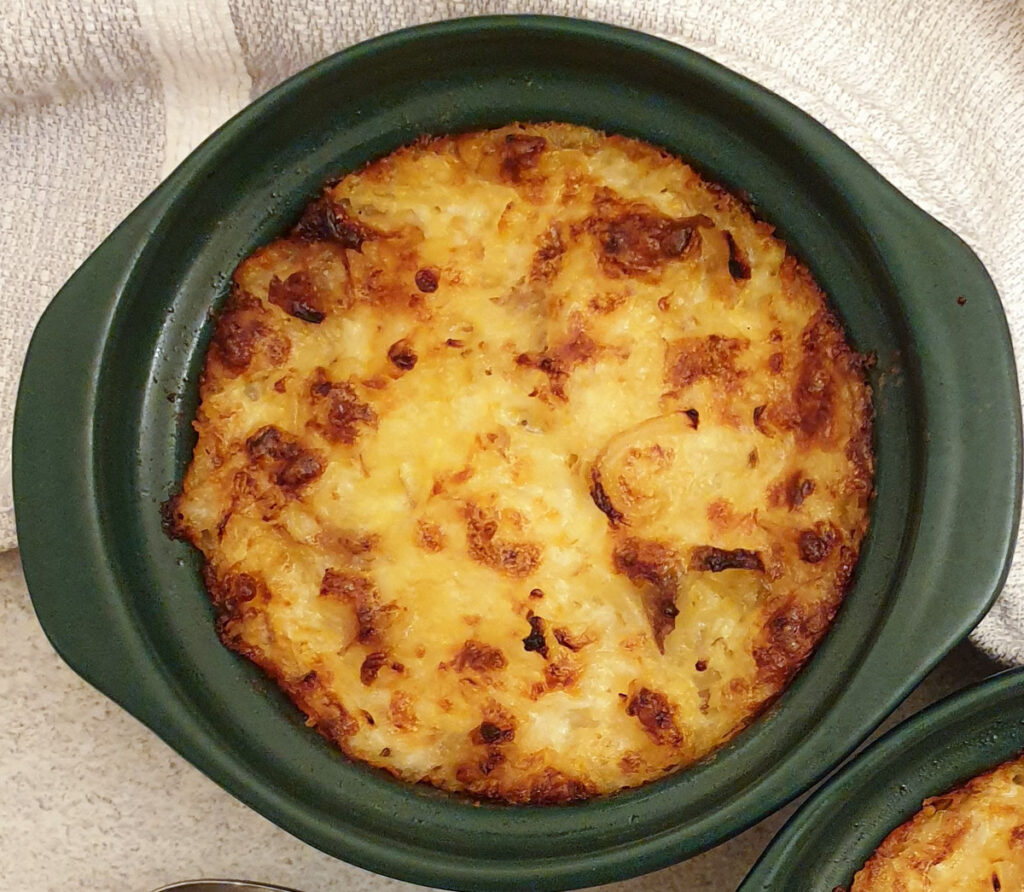 Close up of a baked dish of potatoes Romanoff.