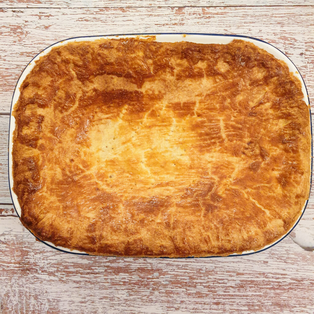 Granny's homemade chicken pie with a golden brown crust after being baked.