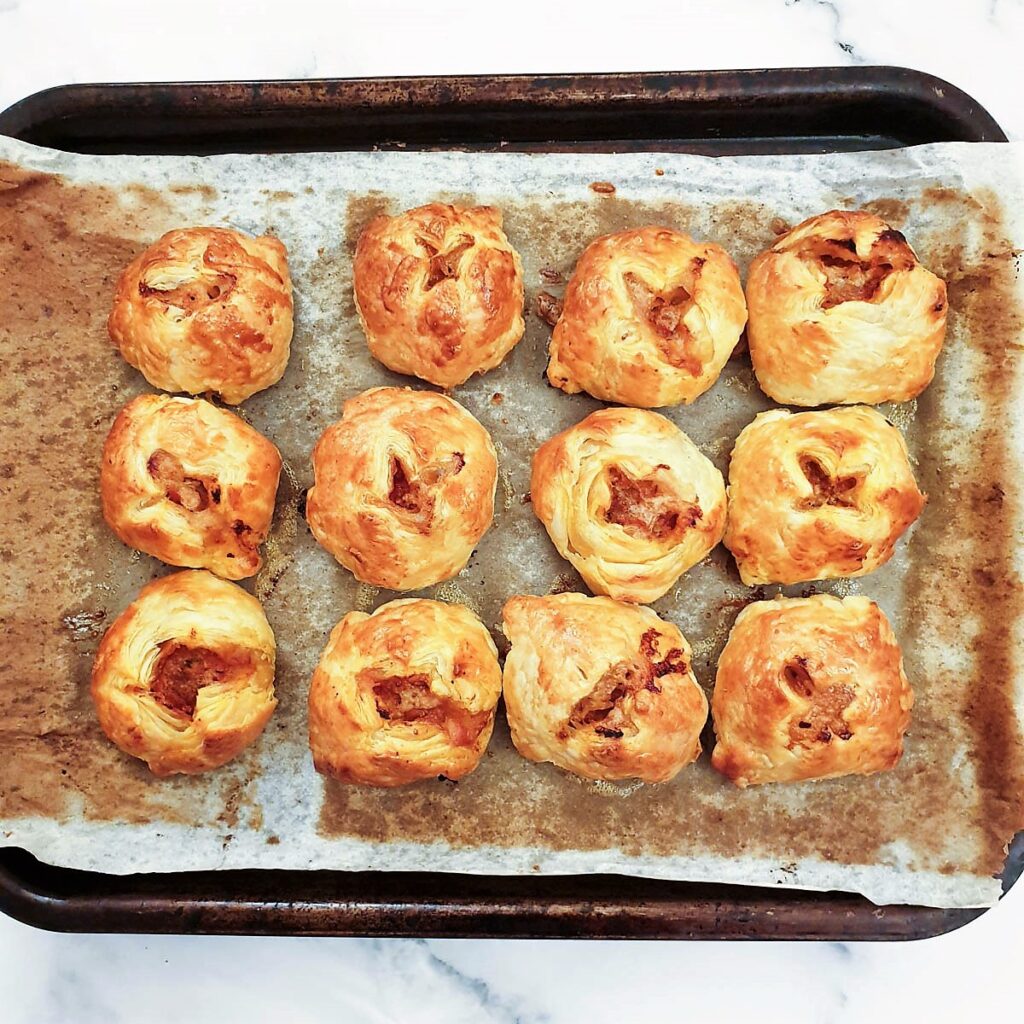 Meatball wellington on a baking tray, fresh from the oven.