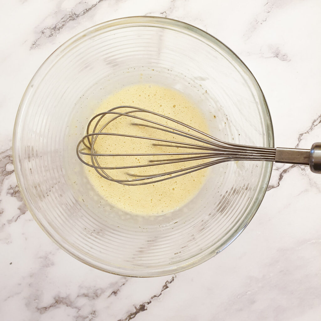 Batter being whisked in a mixing bowl.