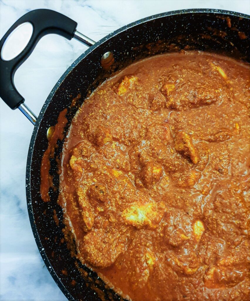 Final shot of chicken tikka masala in a frying pan.