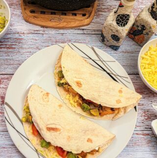 Two fajitas on a plate.