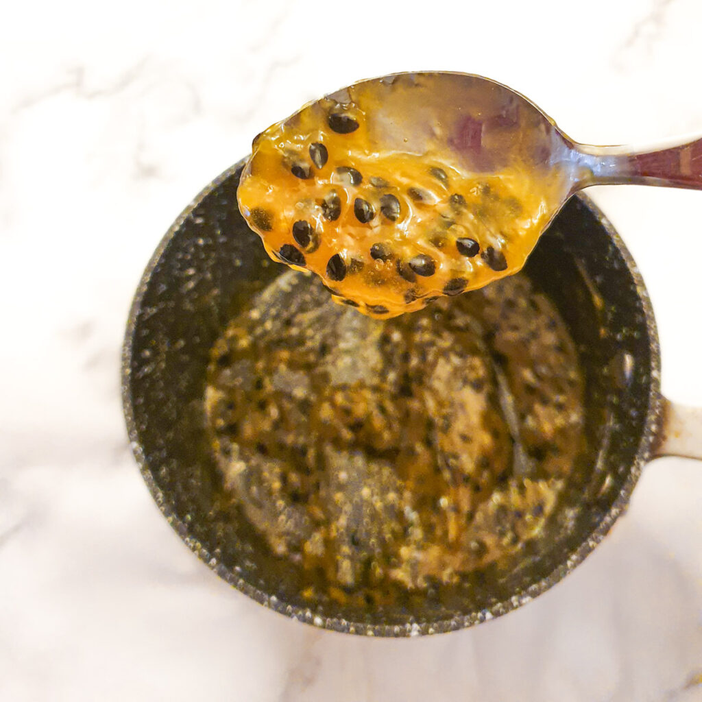 A spoonful of passion fruit topping showing the consistency.