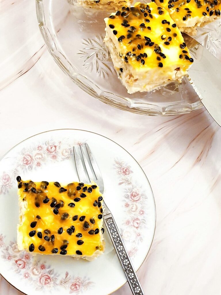 Overhead shot of slices of passion fruit cheesecake on a plate.