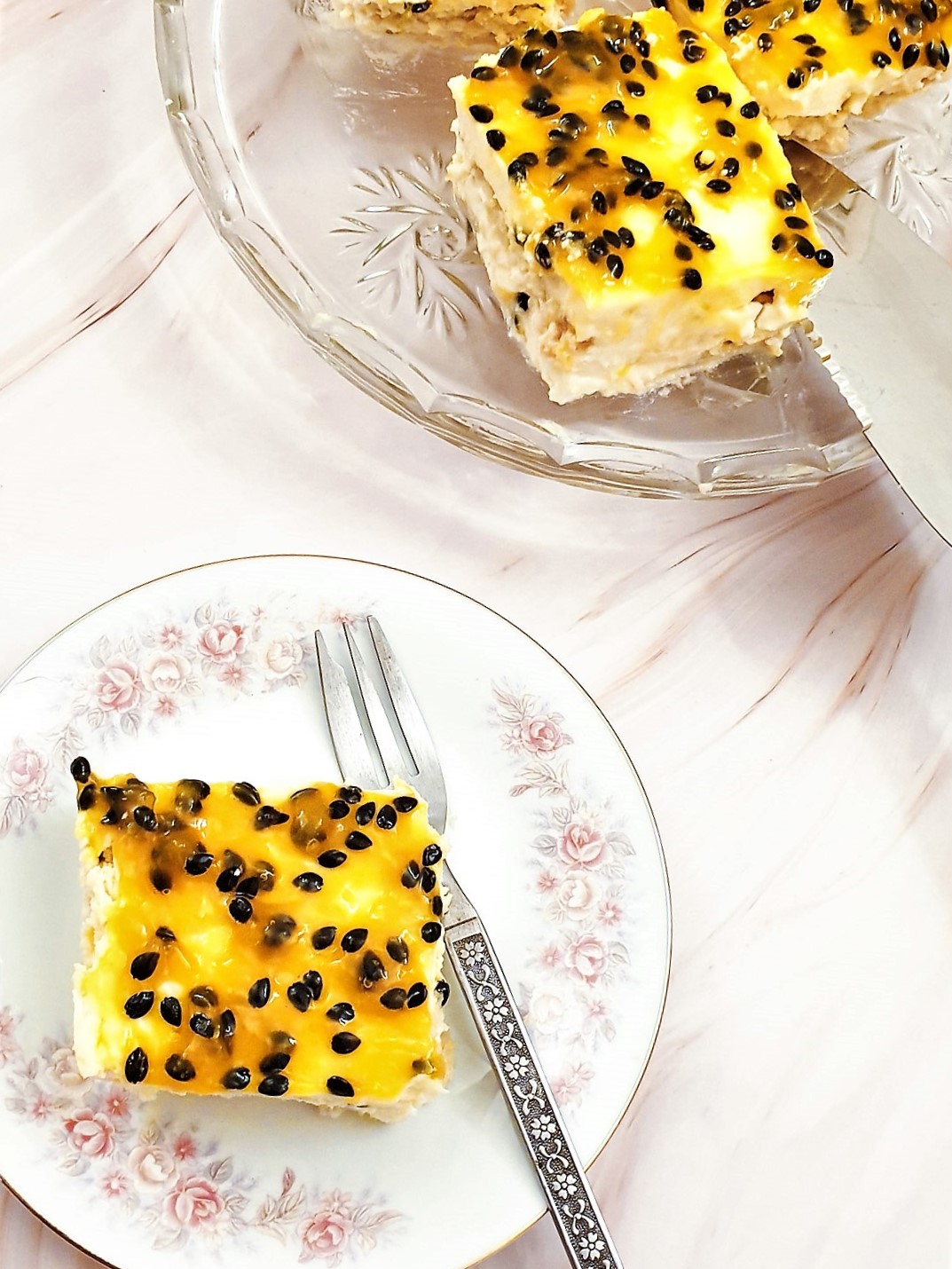 Overhead shot of slices of passion fruit cheesecake on a plate.