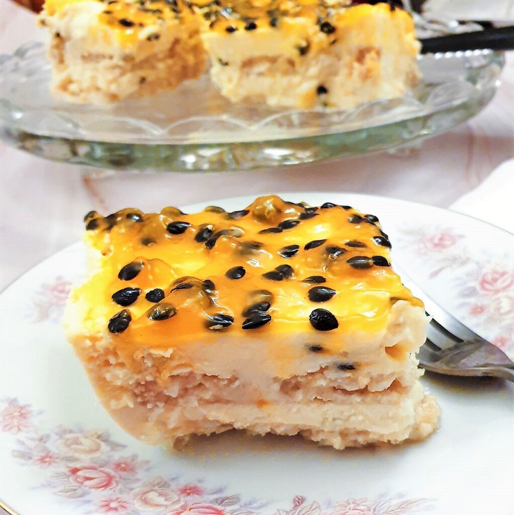 A slice of double passion fruit cheesecake on a plate.