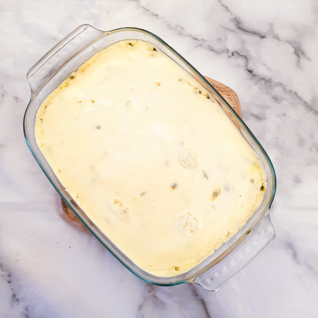 A dish of cheesecake after being cooked in the microwave before the topping has been added.