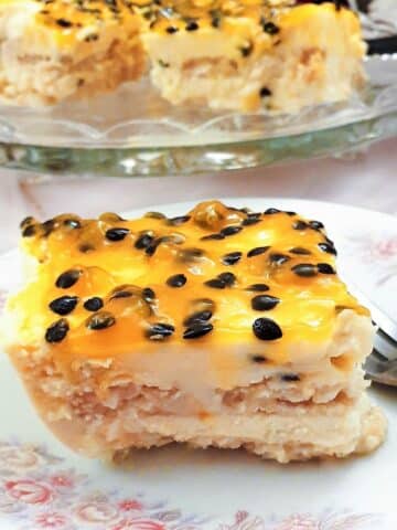 A slice of double passion fruit cheesecake on a plate.