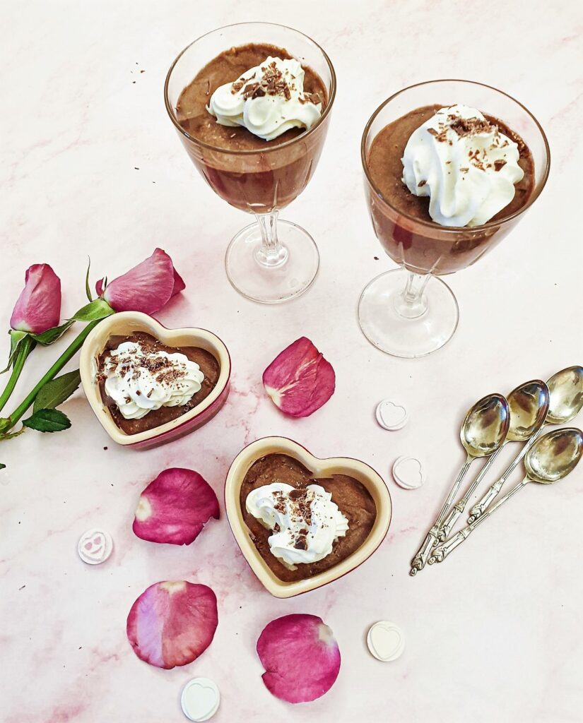 4 dishes of peppermint chocolate mousse decorated with whipped cream.