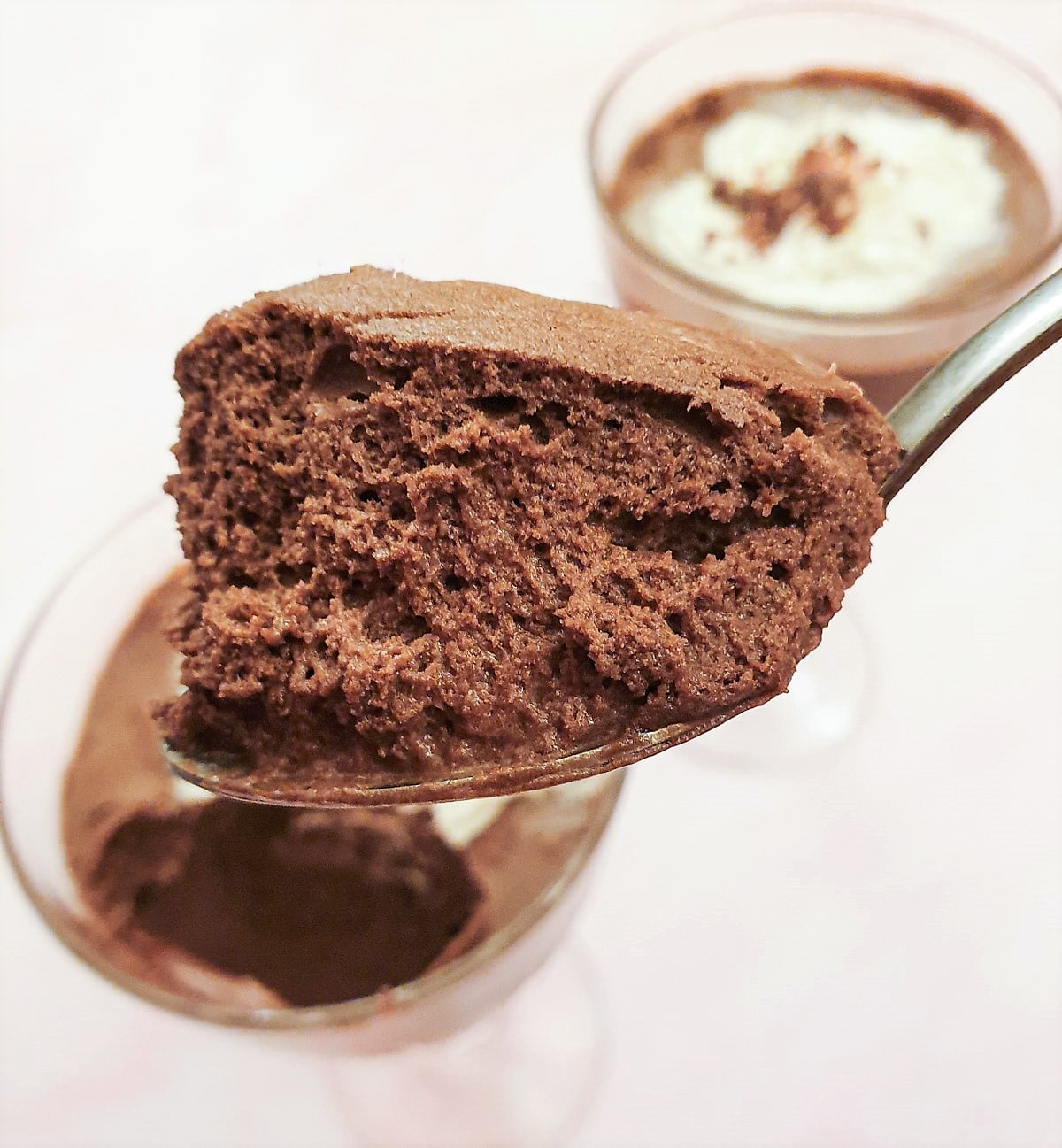 Close up of a spoonful of chocolate mousse, showing the airy texture.