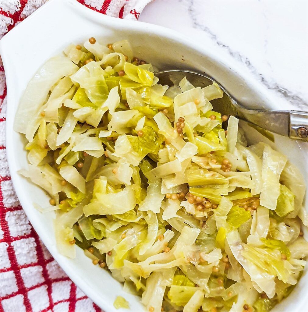 A dish of buttered cabbage and leeks with mustard seeds. A dish of buttered cabbage and leeks with mustard seeds.