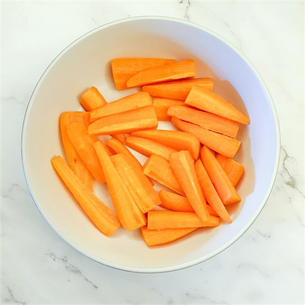 A dish of chopped carrots.