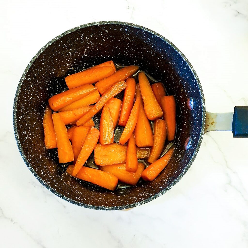 Glazed carrots in a saucepan.