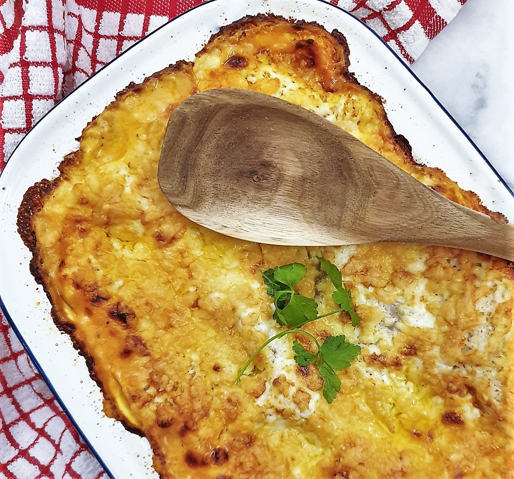 Overhead shot of a dish of cheesy lasagne fresh from the oven.