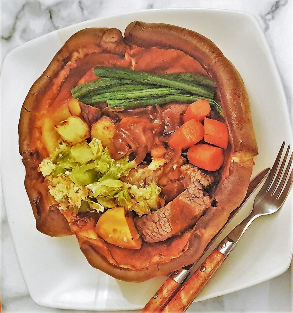 A giant Yorkshire pudding filled with meat and vegetables.