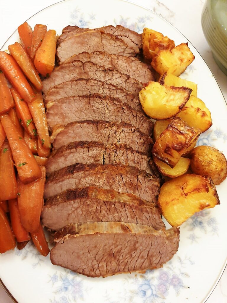 Closeup of a sliced slow-cooked silverside joint.