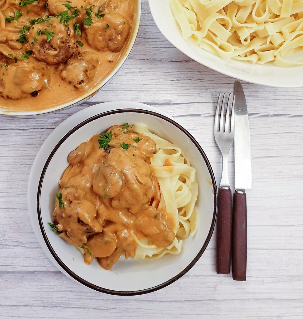 A helping of meatball stroganoff on a bed of tagliatelle.