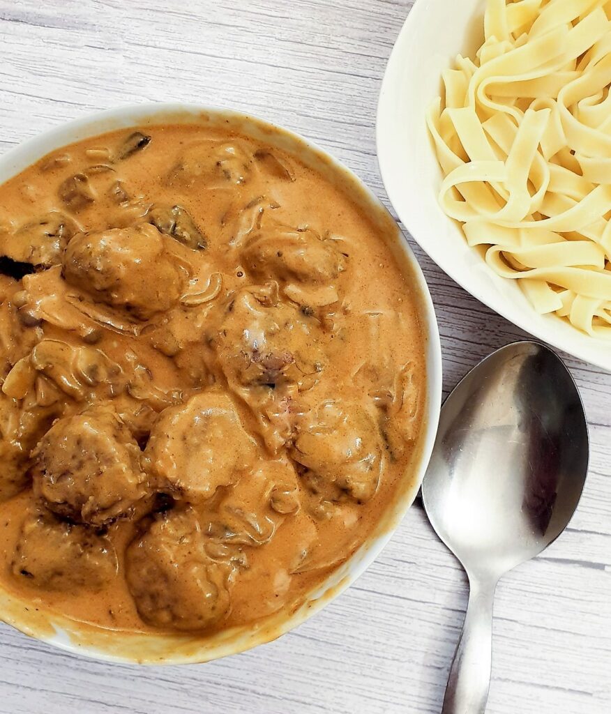 Close up of a serving dish filled with meatball stroganoff.