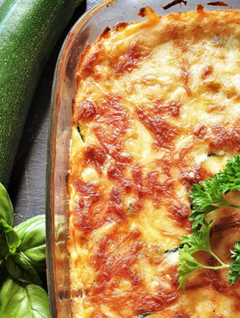 A dish of crustless vegetable quiche with a cheesy toppin