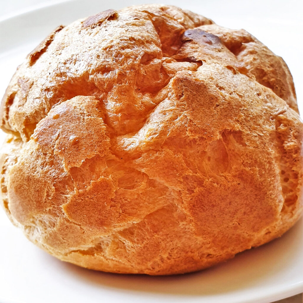 A very puffy cream puff before it is filled.