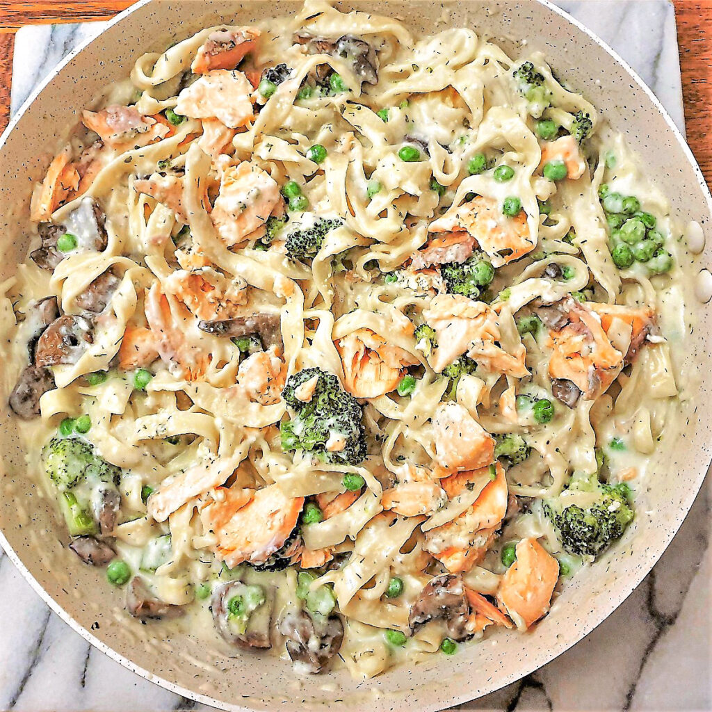 Salmon and broccoli pasta in a frying pan. Salmon and broccoli pasta in a frying pan.