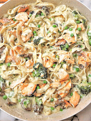 Salmon and broccoli pasta in a frying pan.