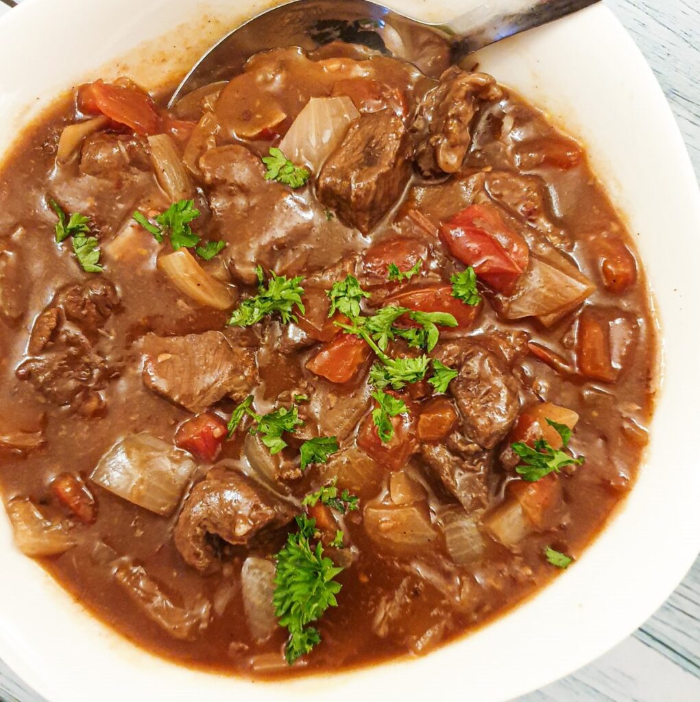 Beef Trinchco in a serving dish garnished with parsley.