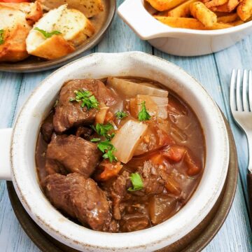 A dish of slow cooked beef Trinchado on a table with a fork.