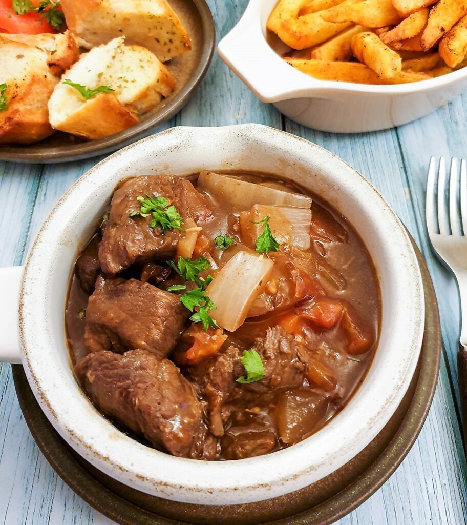 A dish of slow cooked beef Trinchado on a table with a fork.