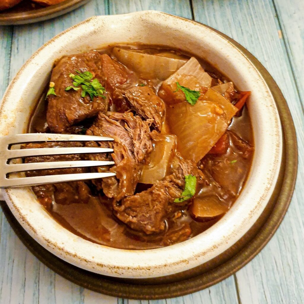 Close up of a dish of beef Trinchado showing the tenderness of the beef.